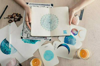 Home 38 a hand holding a white box with blue and white paint